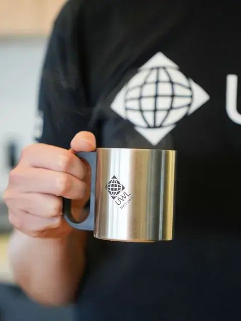 UWL-branded mug at the Itajaí office